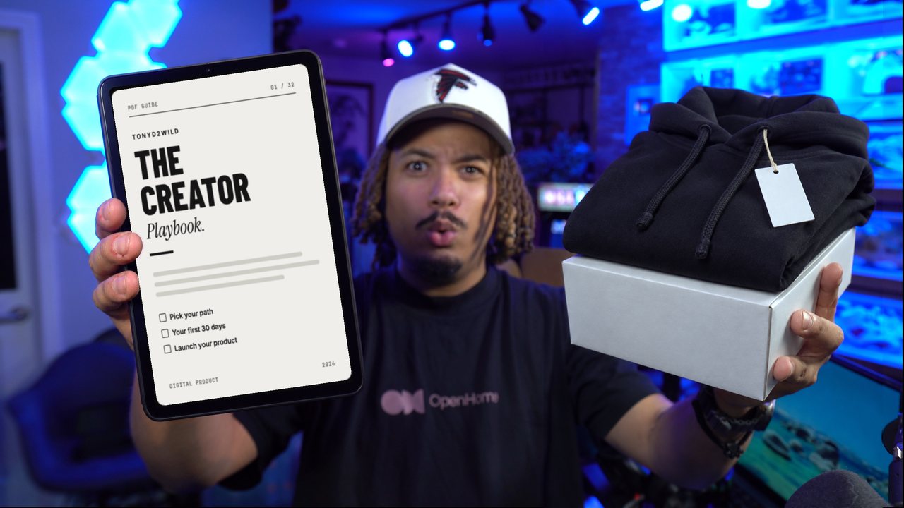 Tony holding a tablet with The Creator Playbook in one hand and a black hoodie on a white box in the other